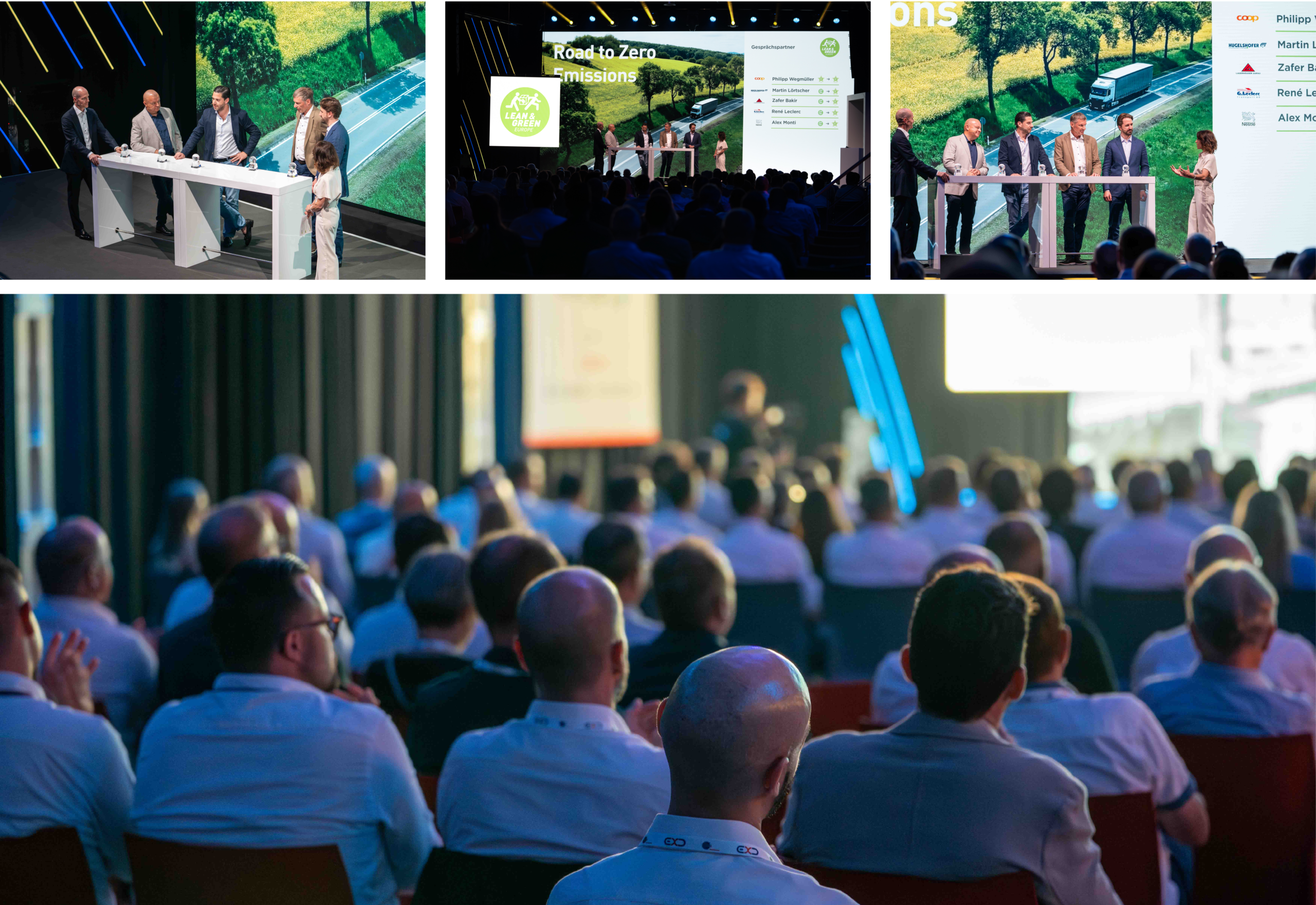 Conference stage with five panelists at a long white table, audience watching a panel discussion in a darkened room with large screens behind them on stage.]?